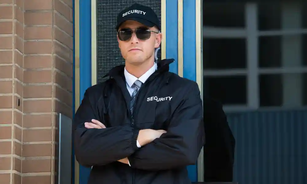 unarmed security guard officer standing in uniform in from of commercial building